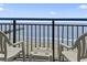 Balcony with chairs overlooking the beach and pier construction at 2300 N Ocean Blvd. # 1430, Myrtle Beach, SC 29577
