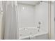 A jetted bathtub with a shower curtain and towel with soap on the side at 2300 N Ocean Blvd. # 1430, Myrtle Beach, SC 29577