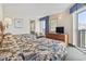 Comfortable bedroom featuring two beds, a dresser with a TV, and access to a private balcony with scenic views at 2300 N Ocean Blvd. # 1430, Myrtle Beach, SC 29577