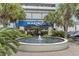Building entrance with a water fountain in front, tropical landscaping, and the Boardwalk sign above the entryway at 2300 N Ocean Blvd. # 1430, Myrtle Beach, SC 29577