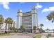 Beautiful exterior view of the Boardwalk Beach Resort with palm trees and blue skies in Myrtle Beach, South Carolina at 2300 N Ocean Blvd. # 1430, Myrtle Beach, SC 29577
