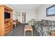 Cozy living room with sofa, armchair, tv, and a view into the kitchen at 2300 N Ocean Blvd. # 1430, Myrtle Beach, SC 29577