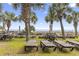 Outdoor lounge area with seating, tables, and palm trees creating a serene and inviting space to relax at 2300 N Ocean Blvd. # 1430, Myrtle Beach, SC 29577