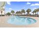 Outdoor pool surrounded by lounge chairs and palm trees, perfect for relaxation and enjoying the sunshine at 2300 N Ocean Blvd. # 1430, Myrtle Beach, SC 29577