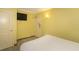 Bright bedroom with essential amenities, including a television and convenient access to the exit, ensuring a comfortable stay at 2301 S Ocean Blvd. # 130, Myrtle Beach, SC 29577