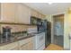 Well-equipped kitchenette with modern appliances, granite countertops, and ample cabinet space for convenient meal prep at 2301 S Ocean Blvd. # 130, Myrtle Beach, SC 29577