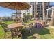 Inviting outdoor lounge area features cozy seating, umbrellas, and a brick firepit for relaxing gatherings at 2301 S Ocean Blvd. # 130, Myrtle Beach, SC 29577