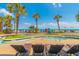 Resort-style lazy river pool with lounge chairs, palm trees, and close proximity to the beach at 2301 S Ocean Blvd. # 130, Myrtle Beach, SC 29577