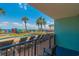 Balcony view of the resort pool area, featuring palm trees, lounge chairs, and beach access at 2301 S Ocean Blvd. # 130, Myrtle Beach, SC 29577