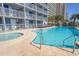 Resort-style pool and hot tub offer relaxation with lounge chairs and ocean views from nearby condos at 2301 S Ocean Blvd. # 130, Myrtle Beach, SC 29577