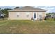 Home's backyard features a green lawn, patio set, and a partial view of the home's exterior at 231 Jeff Waters Circle, Longs, SC 29568