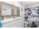 Bathroom featuring a dual sink vanity with framed mirrors and a shower with a vibrant curtain at 231 Jeff Waters Circle, Longs, SC 29568