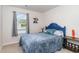 Neutral bedroom showcasing natural light from the window and a charming blue accent bed at 231 Jeff Waters Circle, Longs, SC 29568