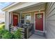 Inviting front porch with seating, decorative touches, and dual entry doors at 231 Jeff Waters Circle, Longs, SC 29568