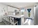 Bright kitchen with white cabinetry, stainless steel appliances, island with seating, and natural light at 231 Jeff Waters Circle, Longs, SC 29568