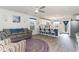 Open concept living space with kitchen island, hardwood floors, and comfortable seating at 231 Jeff Waters Circle, Longs, SC 29568