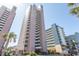 Low angle of condo building with palm trees and blue sky at 2406 N Ocean Blvd. # 803, Myrtle Beach, SC 29577