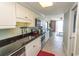 Bright kitchen with black countertops, white cabinets and a view of a sitting room at 2406 N Ocean Blvd. # 803, Myrtle Beach, SC 29577