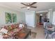 Open-concept living room with tile flooring, tropical accents, and seamless transition to the kitchen area at 2406 N Ocean Blvd. # 803, Myrtle Beach, SC 29577