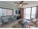 Comfortable living room featuring tile floors, a glass table, and a serene ocean view from the balcony at 2406 N Ocean Blvd. # 803, Myrtle Beach, SC 29577