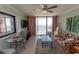 Bright living room boasts a ceiling fan, tile floors, tropical-themed sofa, and stunning ocean views at 2406 N Ocean Blvd. # 803, Myrtle Beach, SC 29577