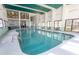Bright indoor pool with several tables and chairs around the perimeter offering lots of natural light at 2406 N Ocean Blvd. # 803, Myrtle Beach, SC 29577