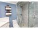 A pristine walk-in shower is seen, with gray marble-look tile, and sliding glass door in this bathroom at 2406 N Ocean Blvd. # 803, Myrtle Beach, SC 29577