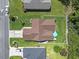 Aerial shot of a home with a brown roof, green lawn, white picket fence, and a blue umbrella on the back patio at 255 Tibton Circle, Myrtle Beach, SC 29588