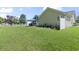 Expansive backyard with a well-maintained lawn, white picket fence, patio, and screened-in porch area at 255 Tibton Circle, Myrtle Beach, SC 29588