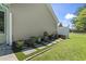 Landscaped backyard featuring a white privacy fence, stepping stones, and multiple potted plants and greenery at 255 Tibton Circle, Myrtle Beach, SC 29588