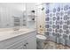Bright bathroom featuring a white vanity and a shower with a patterned curtain at 255 Tibton Circle, Myrtle Beach, SC 29588