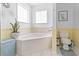 Bright bathroom featuring a soaking tub and window with natural light at 255 Tibton Circle, Myrtle Beach, SC 29588