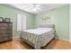 Comfortable bedroom with green walls, shutters, and a ceiling fan at 255 Tibton Circle, Myrtle Beach, SC 29588