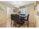 Inviting dining room featuring a modern chandelier, decorative moldings, and a dark wood dining set at 255 Tibton Circle, Myrtle Beach, SC 29588