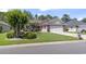 Charming single-story home with manicured lawn, garden bed, brick accents, siding, and an American flag at 255 Tibton Circle, Myrtle Beach, SC 29588
