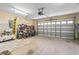 Spacious garage with storage, bicycles, tools, and a functional garage door at 255 Tibton Circle, Myrtle Beach, SC 29588