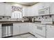 Well-lit kitchen featuring white cabinets, stainless steel appliances, and granite countertops at 255 Tibton Circle, Myrtle Beach, SC 29588