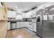 Charming kitchen featuring white cabinets, stainless steel appliances, hardwood floors, and granite countertops at 255 Tibton Circle, Myrtle Beach, SC 29588