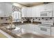 Bright kitchen with white cabinets, stainless steel appliances, and light granite countertops, creating a modern and clean space at 255 Tibton Circle, Myrtle Beach, SC 29588