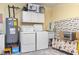 Functional laundry room with washer, dryer, water heater, storage cabinets, and utility sink at 255 Tibton Circle, Myrtle Beach, SC 29588