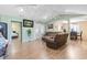 Open-concept living room with neutral walls, wood floors, reclining furniture, and easy access to other rooms at 255 Tibton Circle, Myrtle Beach, SC 29588