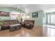 Open living area with reclining sectional, wood floors, and seamless flow to dining and kitchen at 255 Tibton Circle, Myrtle Beach, SC 29588