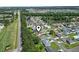Aerial view of a residential neighborhood with tree-lined streets and well-maintained houses near a pond at 255 Tibton Circle, Myrtle Beach, SC 29588