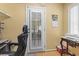 Home office with a desk, ergonomic chair, and a door with built-in blinds at 255 Tibton Circle, Myrtle Beach, SC 29588