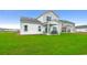 Backyard featuring an attached outdoor patio with two chairs, a bench, and an expansive green lawn at 269 Mayflower Dr., Calabash, NC 28467