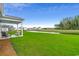 Spacious backyard with a pond view and a covered patio area at 269 Mayflower Dr., Calabash, NC 28467