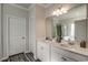 Well-lit bathroom with double vanity, white cabinets, and large mirror at 269 Mayflower Dr., Calabash, NC 28467