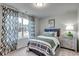 Relaxing bedroom with large windows and patterned curtains at 269 Mayflower Dr., Calabash, NC 28467