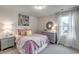 A cute bedroom with pink accents and white blackout curtains at 269 Mayflower Dr., Calabash, NC 28467