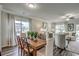 Dining room featuring a wooden table, wicker chairs, neutral walls, large windows, and modern decor at 269 Mayflower Dr., Calabash, NC 28467